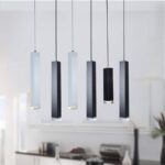 Modern hanging pendant lights over kitchen island in a home setting.